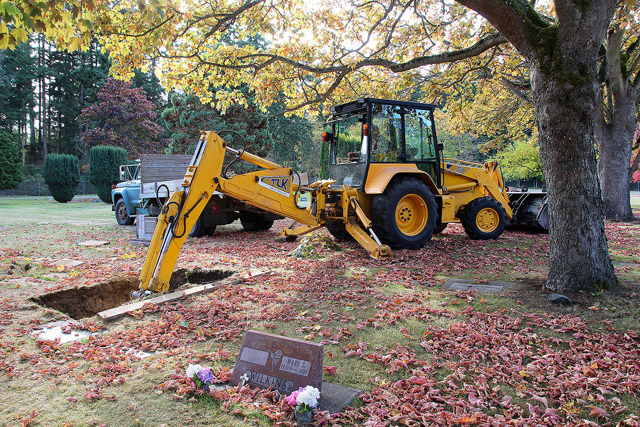 Jessie Stensland / Whidbey News-Times                                Mike Case Smith digs a grave with a backhoe at Maple Leaf Cemetery this week.