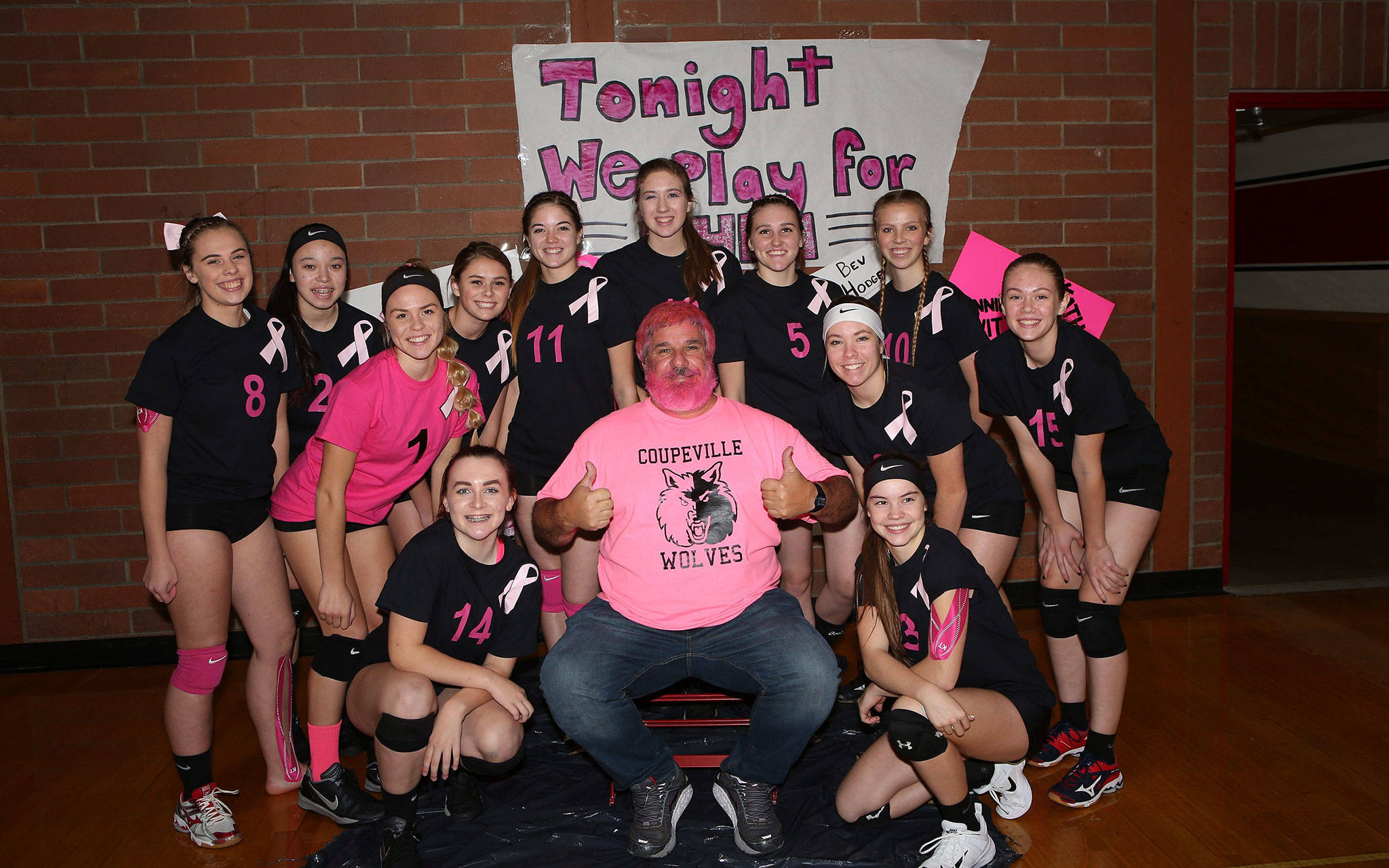 The Coupeville volleyball team celebrated Dig Pink Night, a breast cancer awareness event, Thursday. One of the traditions of the event is to spray John Fisken’s hair and beard pink. Fisken, a local sports photographer, lost his sister Mary to cancer.