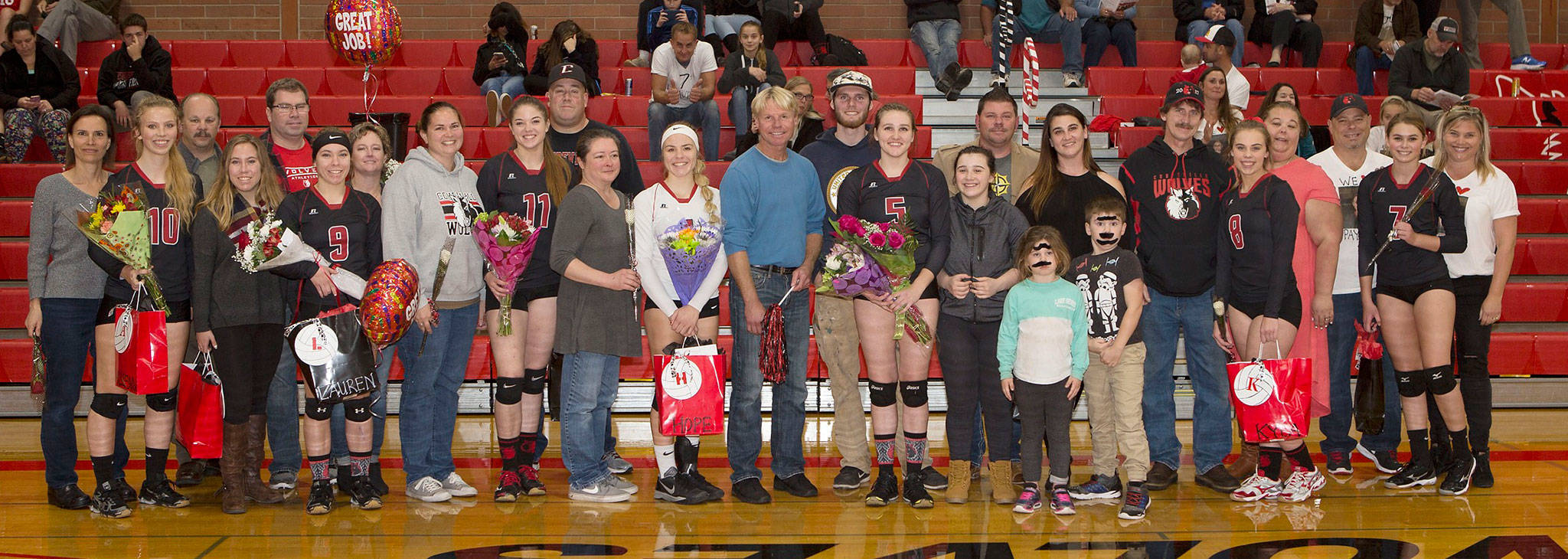 The Coupeville seniors, their familes and their friends were honored Wednesday. The senior players, from the left, are Allison Wenzel (10), Lauren Rose (9), Katrina McGranahan (11), Hope Lodell (white jersey), Mikayla Elfrank (5), Kyla Briscoe (8) and Payton Aparicio (7). Senior manager Kayla Rose is fourth from the left. (Photo by John Fisken)