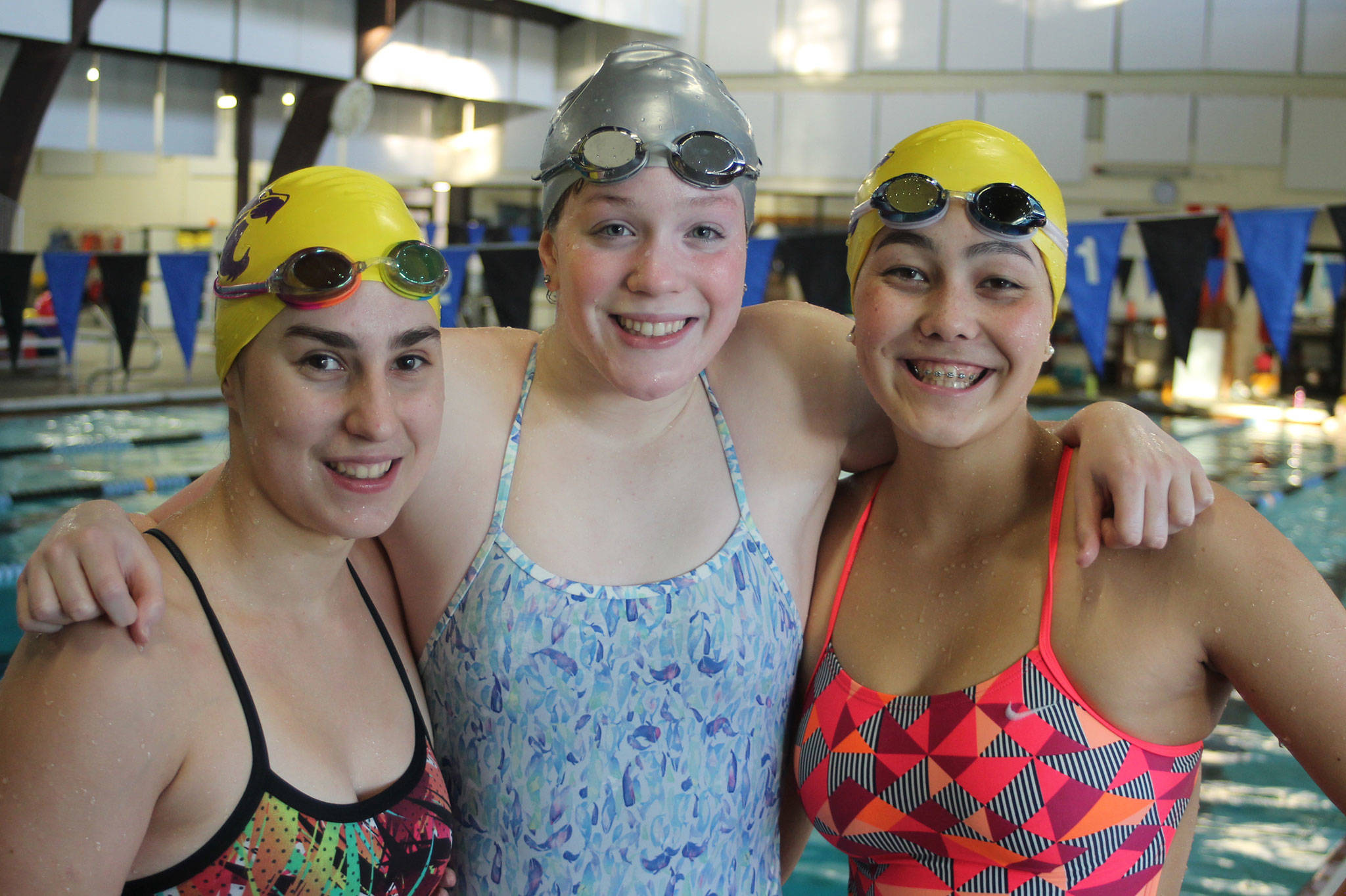 Oak Harbor seniors Taliah Black, left, Jillian Pape and Olivia Tungate will lead the Wildcats into the swimming postseason this weekend. (Photo by Jim Waller/Whidbey News-Times)