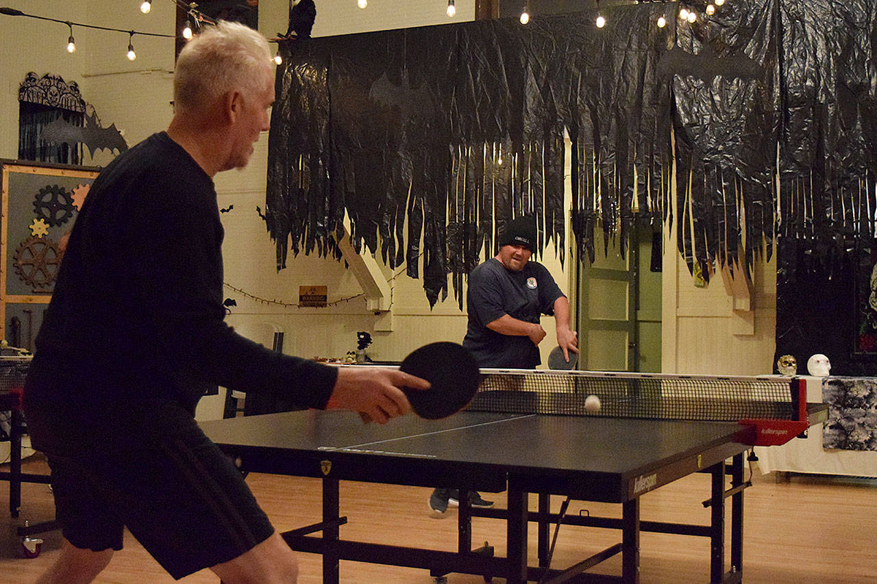 Kyle Jensen / The Record — Ping-pong regular Chris Campbell (right) takes on organizer Bob Bowling (left) on Tuesday night.