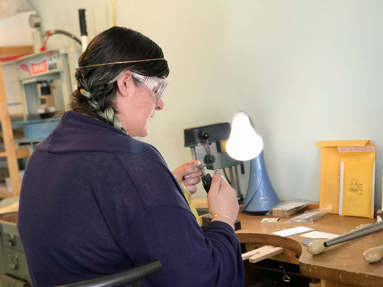 Rosalie Gale photo — Foamy Wader owner Alexa Allamano works on one of her nautical-themes pieces of jewelry in her Langley storefront.