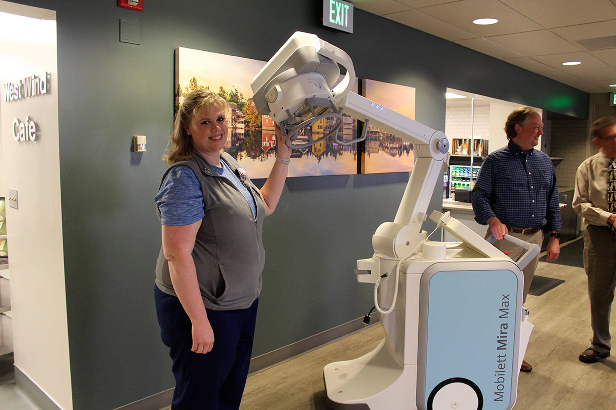 Lead imaging technologist Amanda Garlock shows off a new mobile x-ray machine following a WhidbeyHealth board meeting. The public health system announced Monday its replacing all its diagnostic imaging machines under a new agreement with Siemens Healthineers.                                Photo by Patricia Guthrie/Whidbey News-Times