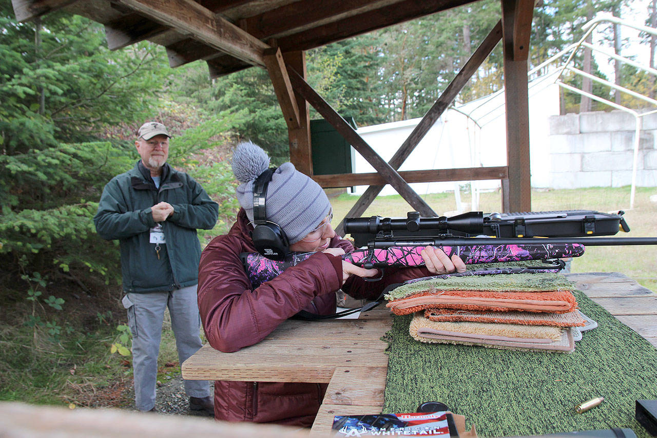 Photo by Jessie Stensland / Whidbey News-Times                                Instructor John Hellmann watches Stephanie Steinbrecher practice at North Whidbey Sportsmens Club range last week.