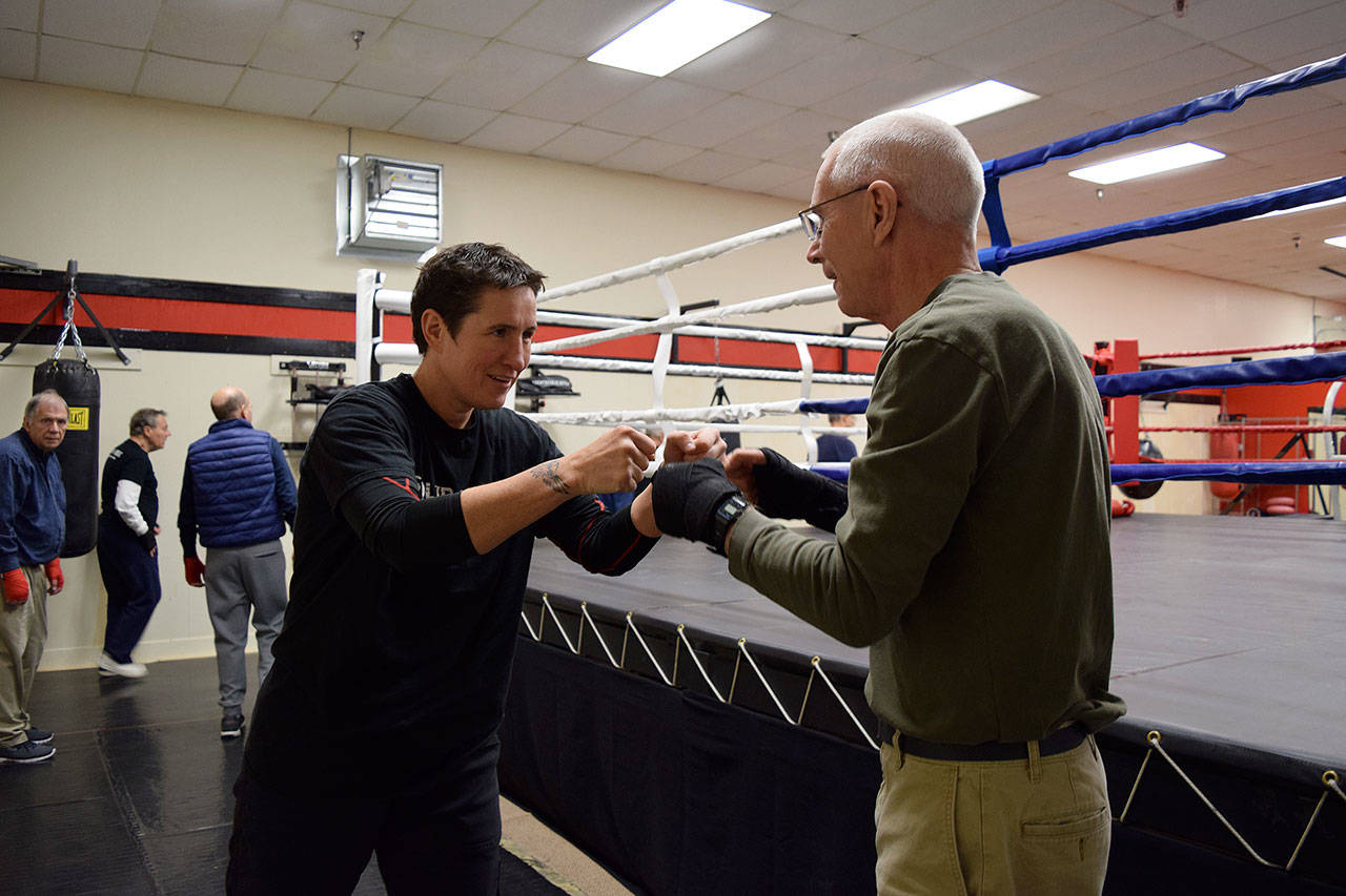 Kyle Jensen / The Record — Solid Stone Boxing owner Dakota Stone (left) fist bumps boxer David Harbison (right) after a session.