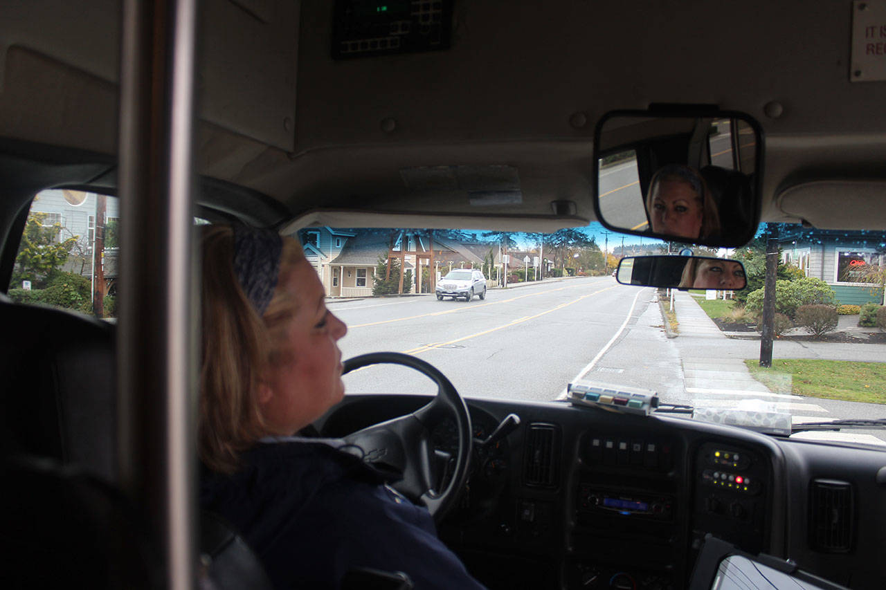 Teresa Davis, known as “T” to her bus riders, says she enjoys her Island Transit driving job for the variety of routes she serves. The company celebrates 30 years Friday. Photo by Patricia Guthrie/Whidbey News-Times