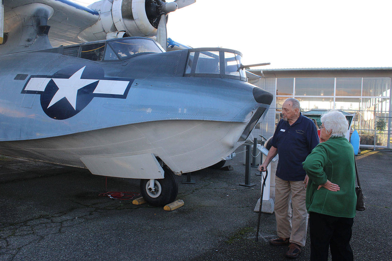 PBY Naval Museum board chairman Richard Rezabek gives a tour of the PBY 5-A Catalina seaplane that’s a popular attraction. However, sometimes there’s not enough volunteers to accompany visitors to the plane, he says.                                Photo by Patricia Guthrie/Whidbey News-Times