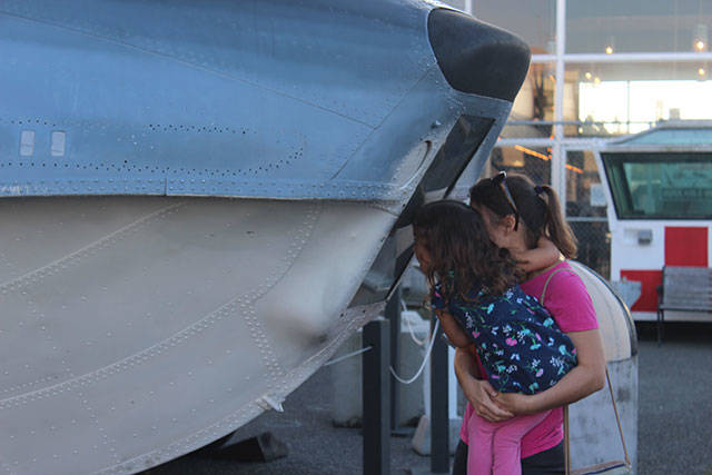 Jennifer Zovar peeks into float space of the seaplane with her daughter Helen. They visited Veteran’s Day weekend from Bellingham.                                Photo by Patricia Guthrie/Whidbey News-Times