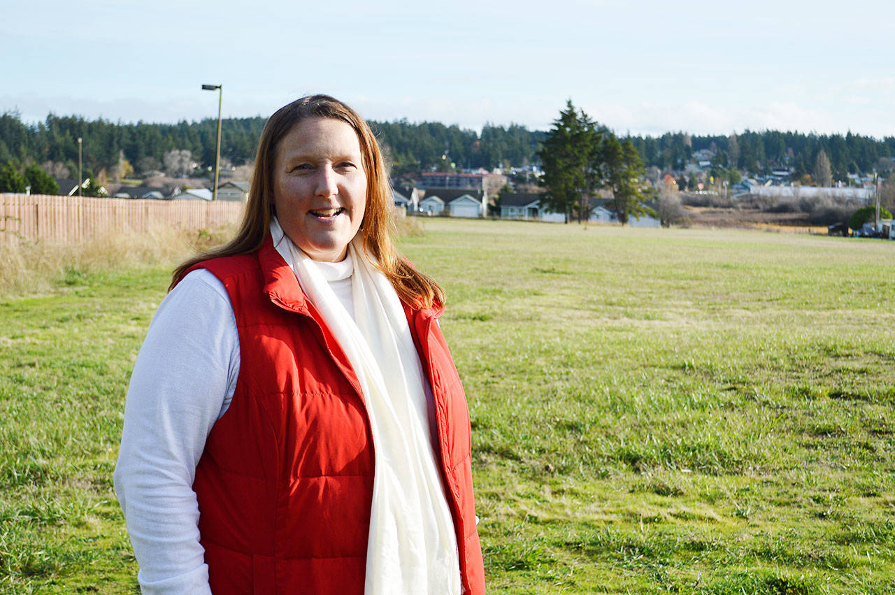 County Commissioner Jill Johnson stands in front of the property that Island County is in the process of purchasing for a crisis center and affordable housing complex. The seven-acre parcel is located in Oak Harbor and would serve Island, Skagit and San Juan counties. Photo by Laura Guido/Whidbey News-Times