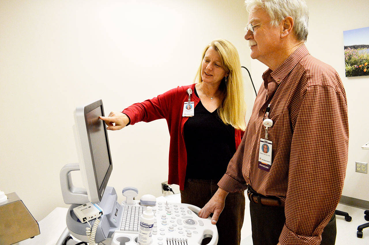 Kay Draper, clinic manager, and Dr. Robert Burnett use the new ultrasound machine at the WhidbeyHealth Women’s Care clinic in Oak Harbor. The new clinic is in the same building as the hospital’s sleep care, primary care and physical therapy facilities. Photo by Laura Guido/Whidbey News-Times