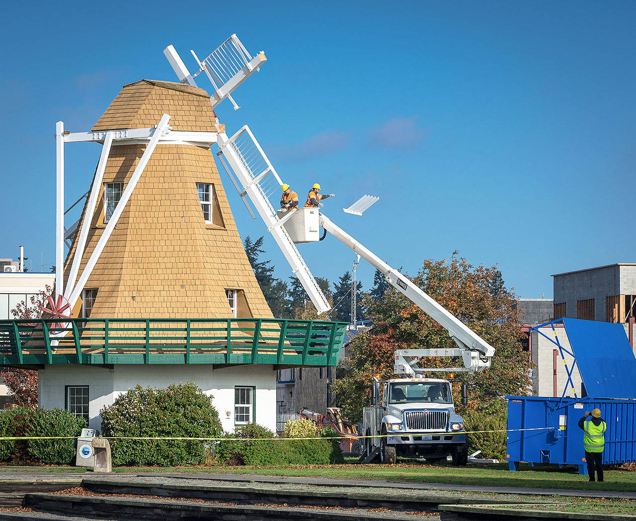 Photo by Pam Headridge                                Workers remove the paddles on the windmill in Oak Harbor’s Windjammer Park in October.
