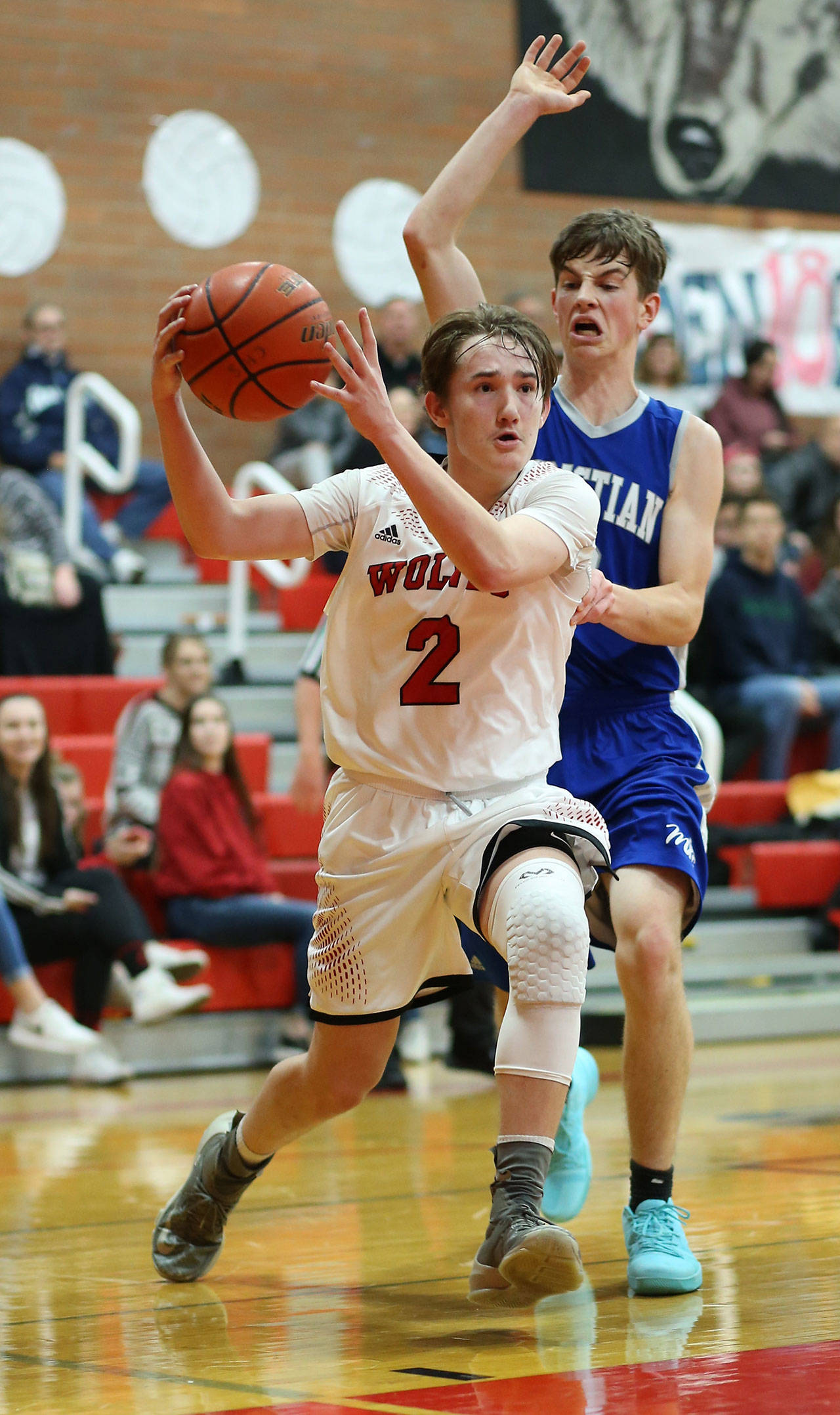 Ethan Spark (2) attacks the hoop Friday. Spark, however, did most of his damage from the outside, sinking five three-pointers.(Photo by John Fisken)