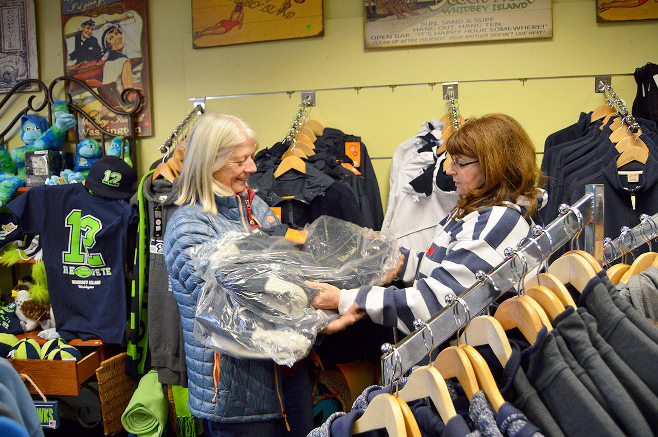 Patti Brigman, right, and Vickie Chambers, left, collect items from Brigmans Coupeville shop Back to the Island to donate for the Coupeville Community Care Teams annual drive. Photo by Megan Hansen/Whidbey News Group