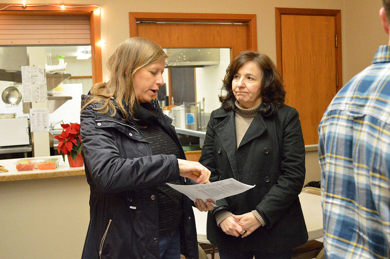 Lori Taylor, left, asks questions to Beverly Mesa-Zendt, assistant planning director, during an affordable housing open house on Thursday. The North Whidbey Affordable Housing Task Force presented its recommendations to address housing issues in island county. Photo by Laura Guido/Whidbey News-Times