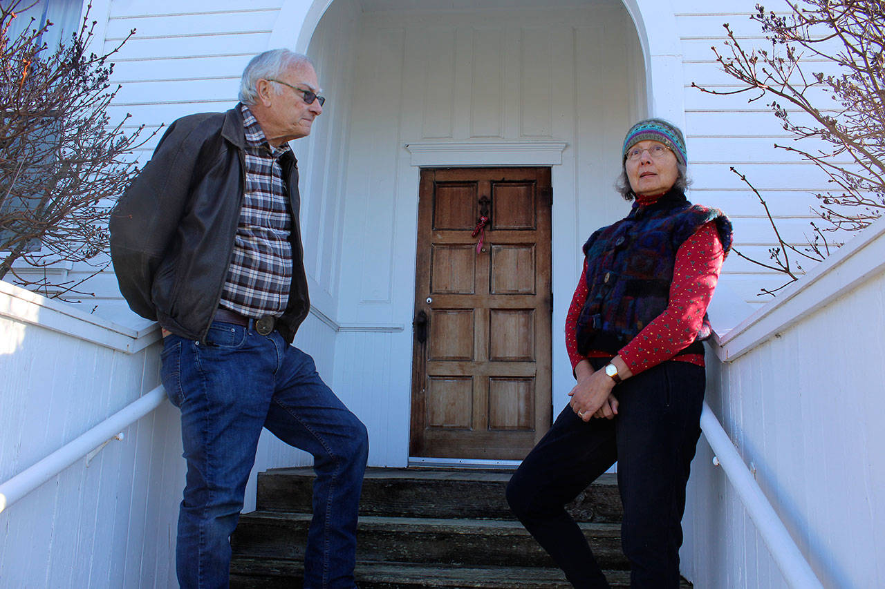 Bill and Jan Skubi pose in front of old San de Fuca school house looking out on Penn Cove. The married Coupeville couple are both poets and active in the new group, Oak Harbor Poetry Project. Bill Skubi will be reading his poems Sunday, including one about the former school house.                                Photo by Patricia Guthrie/Whidbey News-Times