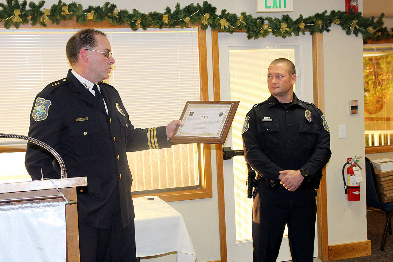 Photo by Jessie Stensland / Whidbey News-Times                                Oak Harbor Police Chief Kevin Dresker presents Officer Michael Brown with the department’s Medal of Distinction.