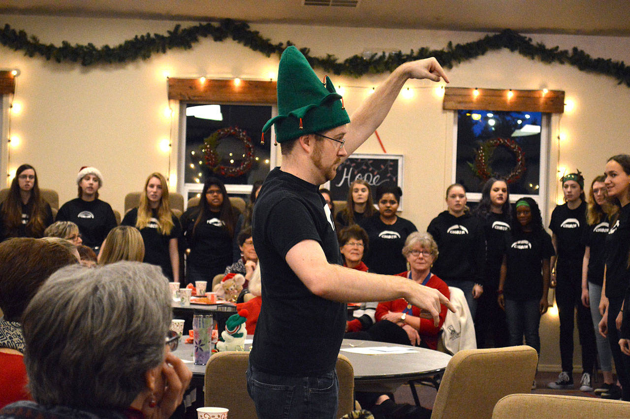 Darren McCoy, choir teacher at Oak Harbor High School, directs his students in a performance at Family Bible Church Friday morning. McCoy has been named as one of 1o finalists for the Grammy Music Educator Award. Photo by Laura Guido/Whidbey News-Times