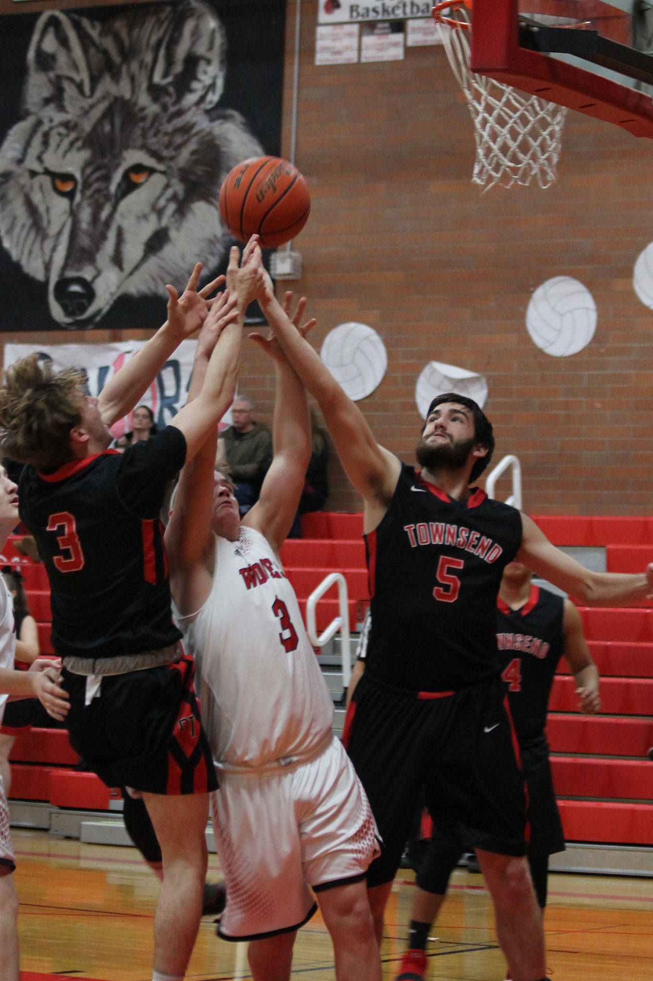 Coupeville’s Hunter Downes (3) battles taller Port Townsend players for a rebound in Tuesday’s win. (Photo by Jim Waller/Whidbey News-Times)