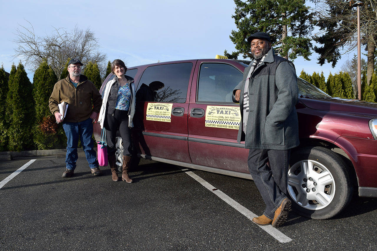 Kyle Jensen / The Record — The leadership at Safe Ride Home is ready to get the wheel rolling again. Left to right: founder Brian Grimm, advisor Jessica Leon and All Island Taxi driver Tony Caldwell.