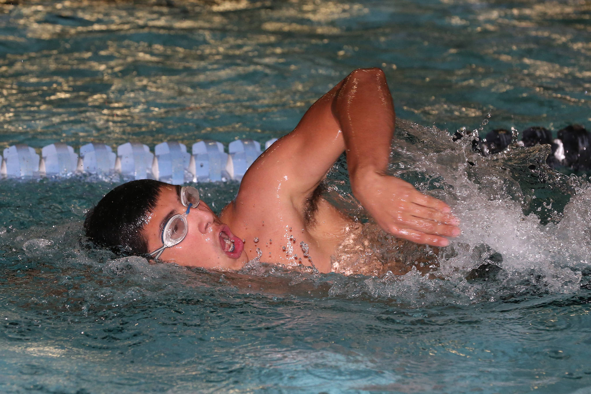 Aaron Martinez swims his way to first place in the 100-meter freestyle.(Photo by John Fisken)