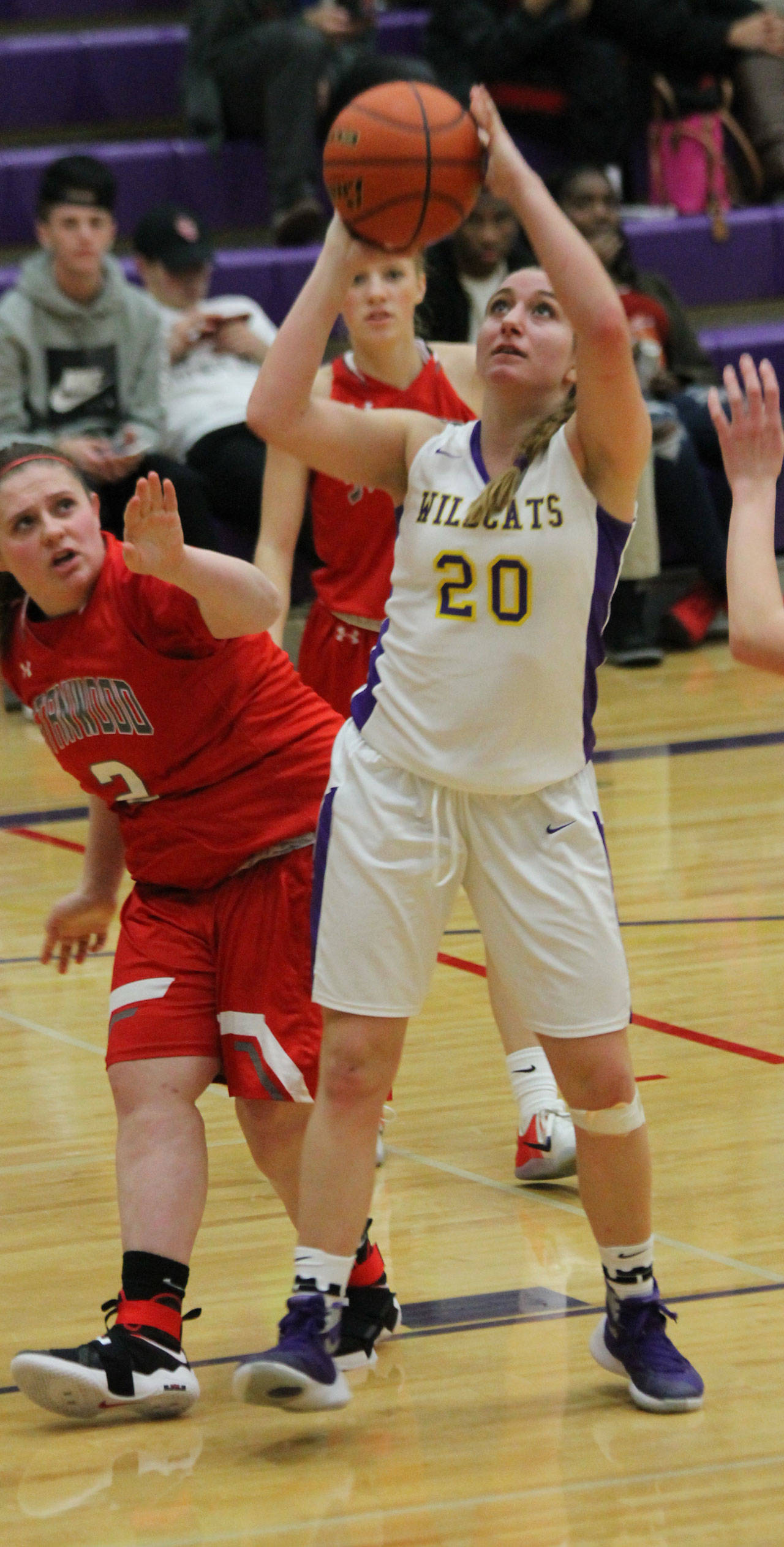 After grabbing an offensive rebound, Samantha Hines (20) puts up a shot over Stanwood’s Allie Jones. (Photo by Jim Waller/Whidbey News-Times)