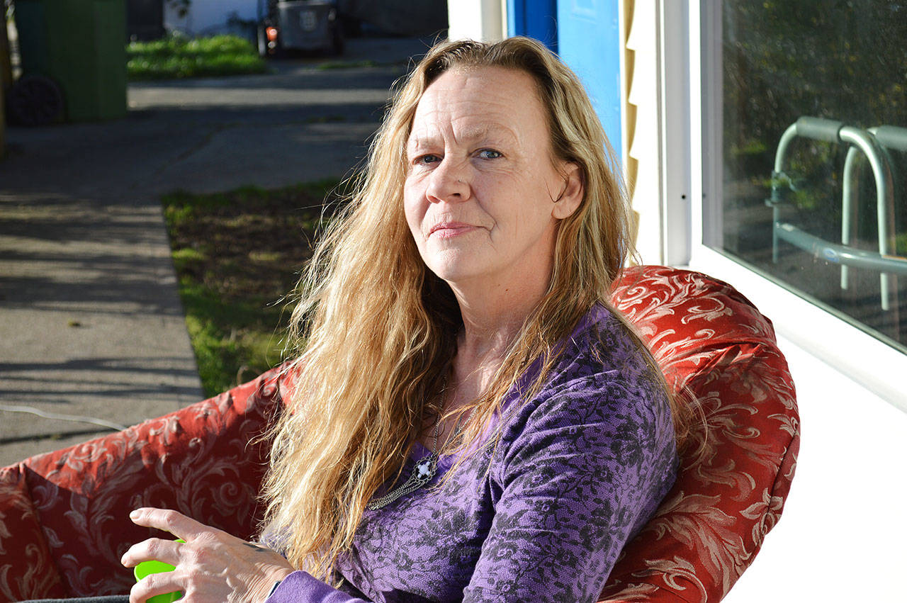Donna Moore sits outside of her Oak Harbor apartment. She recently received a letter from her landlord that her rent would likely be increasing, and with the lack of affordable housing on the island, she’s afraid she’ll have to live her lifelong home. Photo by Laura Guido/Whidbey News-Times