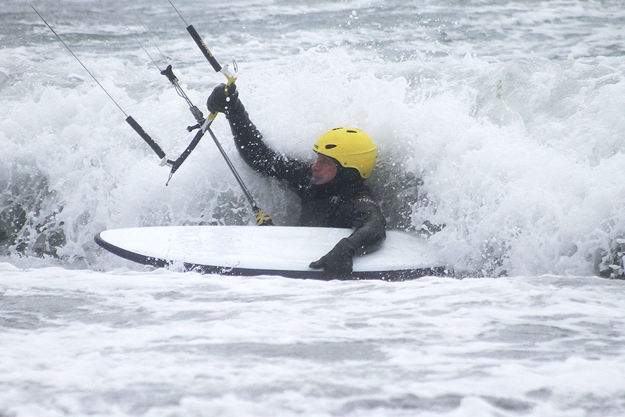 Evan Thompson / The Record — Freeland resident Scott Robbins battles waves as he attempts to kitesurf during a windy morning on Dec. 28 at Useless Bay.
