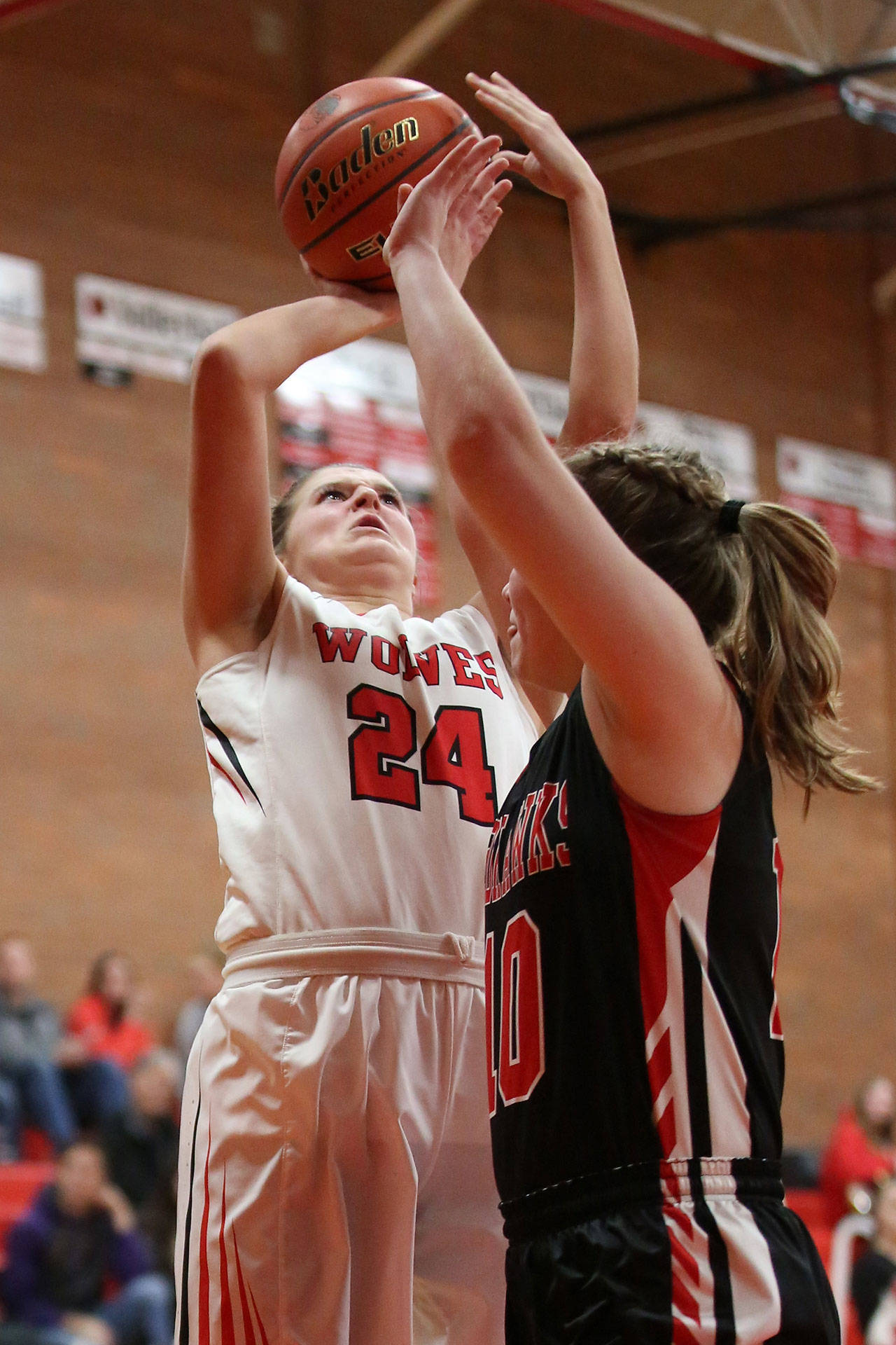 Lindsey Roberts shoots over the defense of Port Townsend’s Cece Nielsen.(Photo by John Fisken)