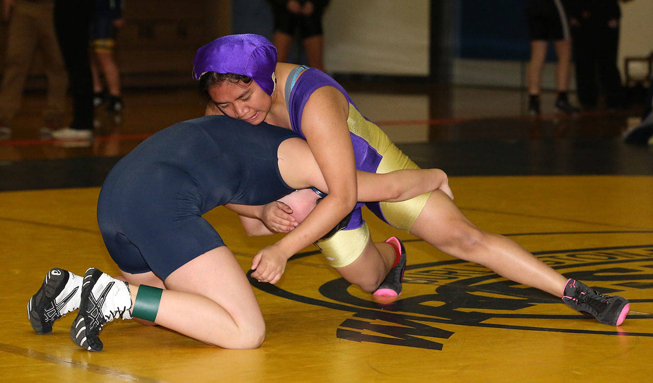 Grace Chargualaf, right, works for a takedown during Wednesday’s match. (Photo by John Fisken)