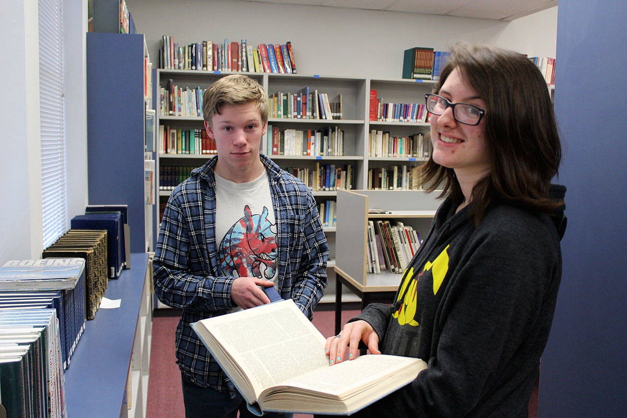 Jacob T. Smith and Raechel Kundert, seniors at Coupeville High School, are working on a project to bring new life to the school library. Photo by Patricia Guthrie/Whidbey News-Times