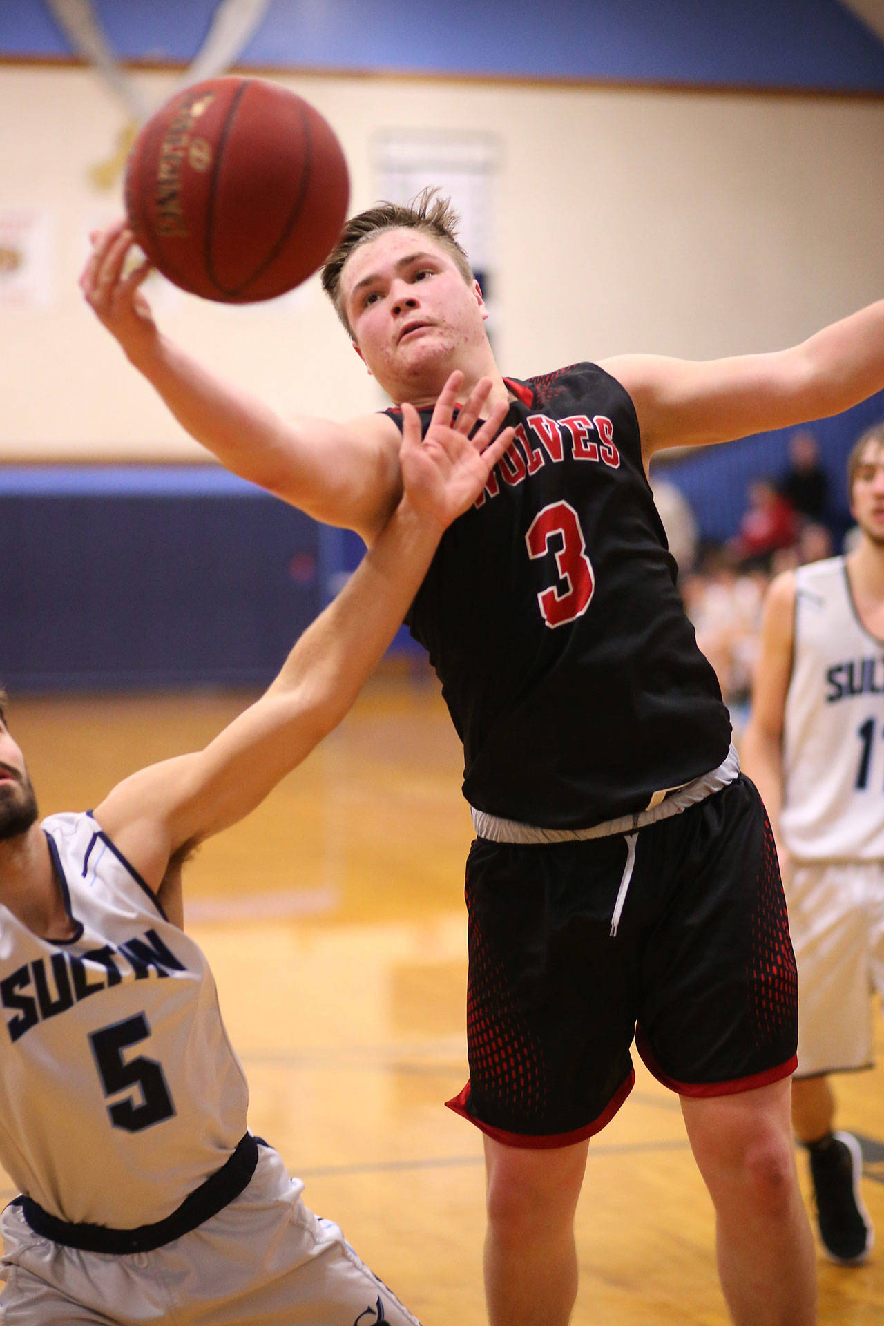 Coupeville’s Hunter Downes grabs a rebound at Sultan Saturday. (Photo by John Fisken)