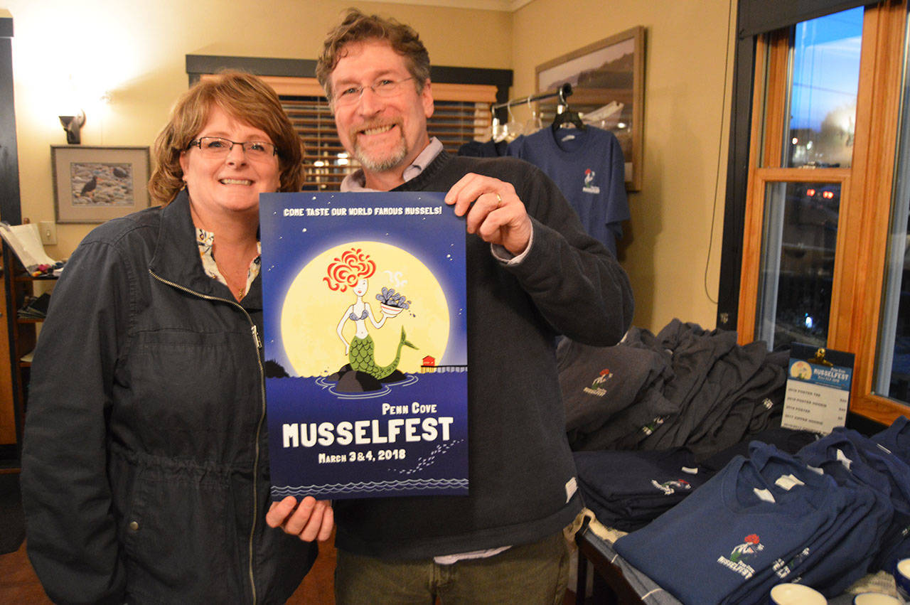 Photo by Megan Hansen/Whidbey News-Times                                Scott and Kerry Rosenkranz of Rosenkranz Productions show off the poster they created for this year’s Penn Cove Mussel Festival.