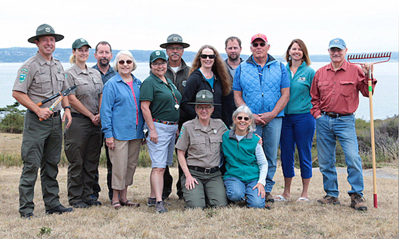 Rangers and staff of Whidbey’s seven state parks pose with the founding members of Friends of Whidbey State Park. In the front row kneelinng is park naturalist Janet Hall (left) and lead Friends organizer Margie Parker. Photo provided