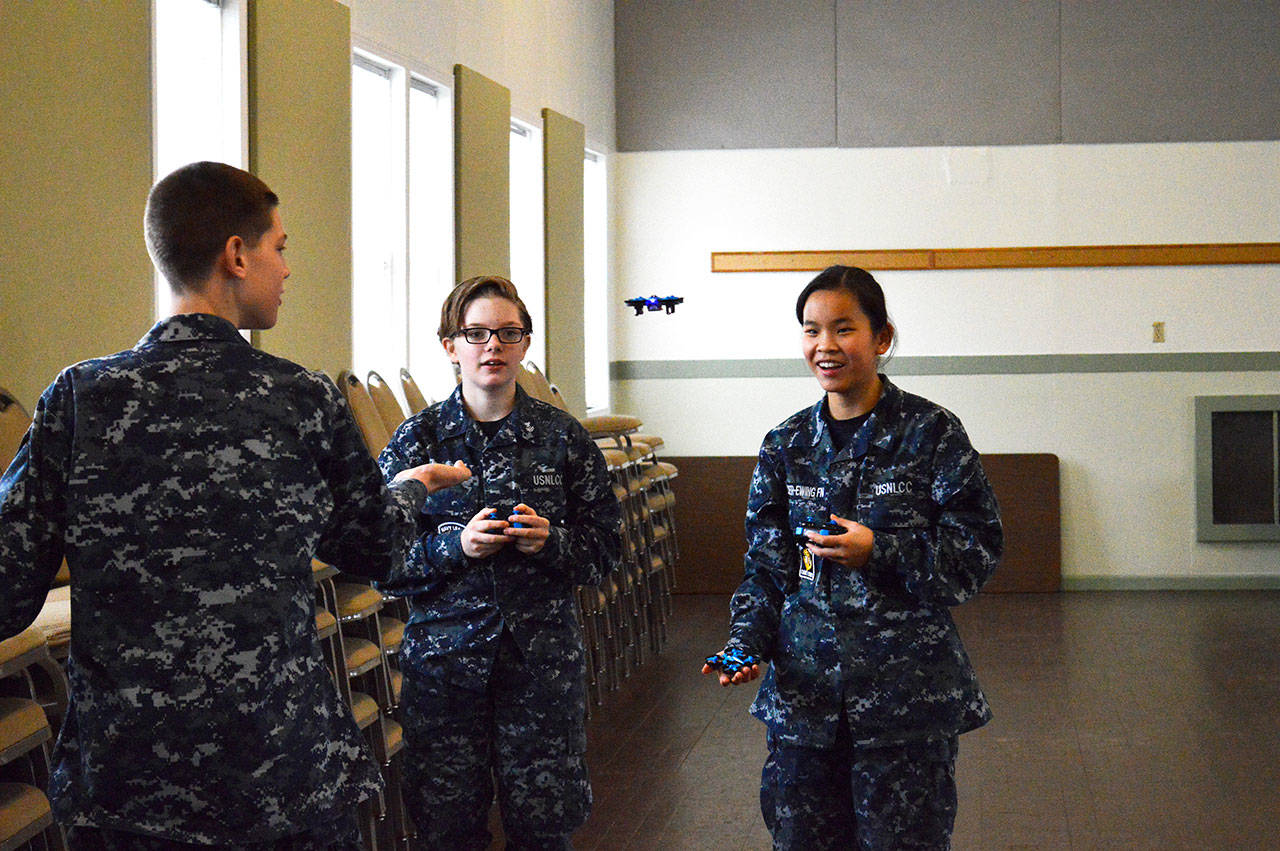 From left, Elijah Lisenby, Kenna Kooyman and Fia Cooper-Ewing practice using small drones during winter Sea Cadet training at Camp Casey. Photo by Laura Guido/Whidbey News-Times