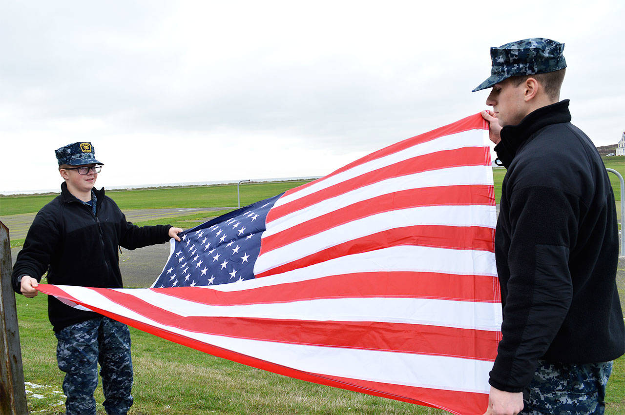 Left, Travis Finning and Almazano Bergeron practice folding the flag at Sea Cadet winter training at Camp Casey. The training ran from Dec. 26-Jan. 1 and 76 cadets attended. Photo by Laura Guido/Whidbey News-Times