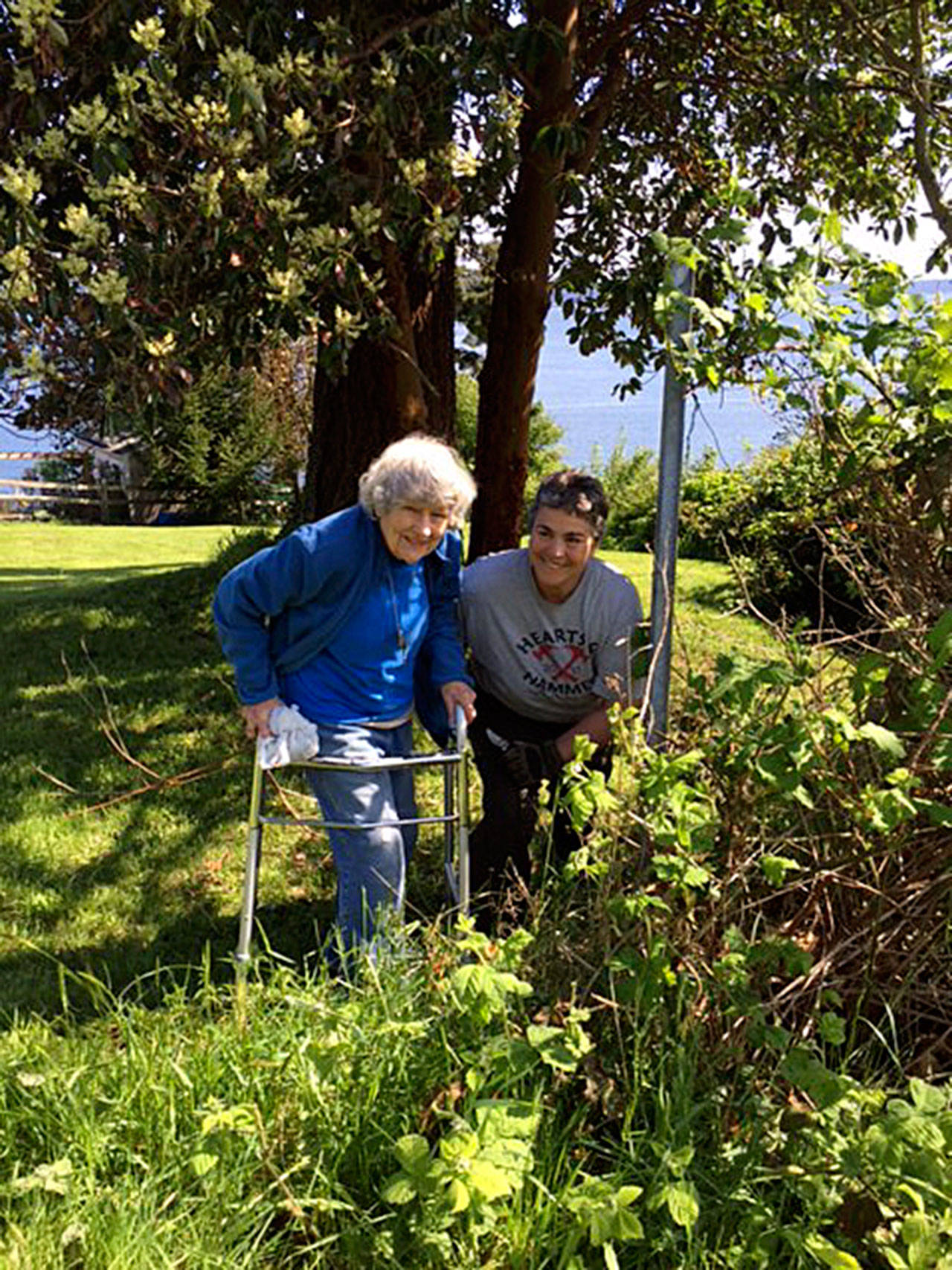 Last year, Cris Sanguin (right) led a team of Central Whidbey Hearts & Hammers volunteers to provide loving lawn care for Florence Harves, who was thrilled with the results. Photo provided