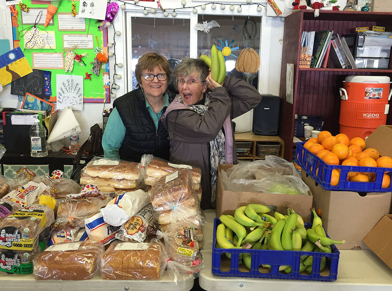 Judy Smith and Anni Campbell volunteer at Gifts from the Heart Food Bank, which is celebrating its 16th birthday today. Photo provided by Molly Hughes