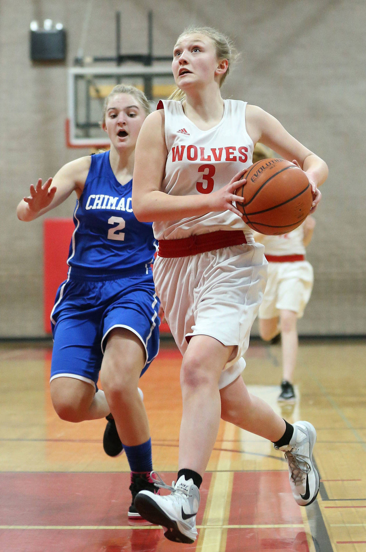 Anya Leavell takes the ball to the hoop for the Coupeville eighth-graders. (Photo by John Fisken)