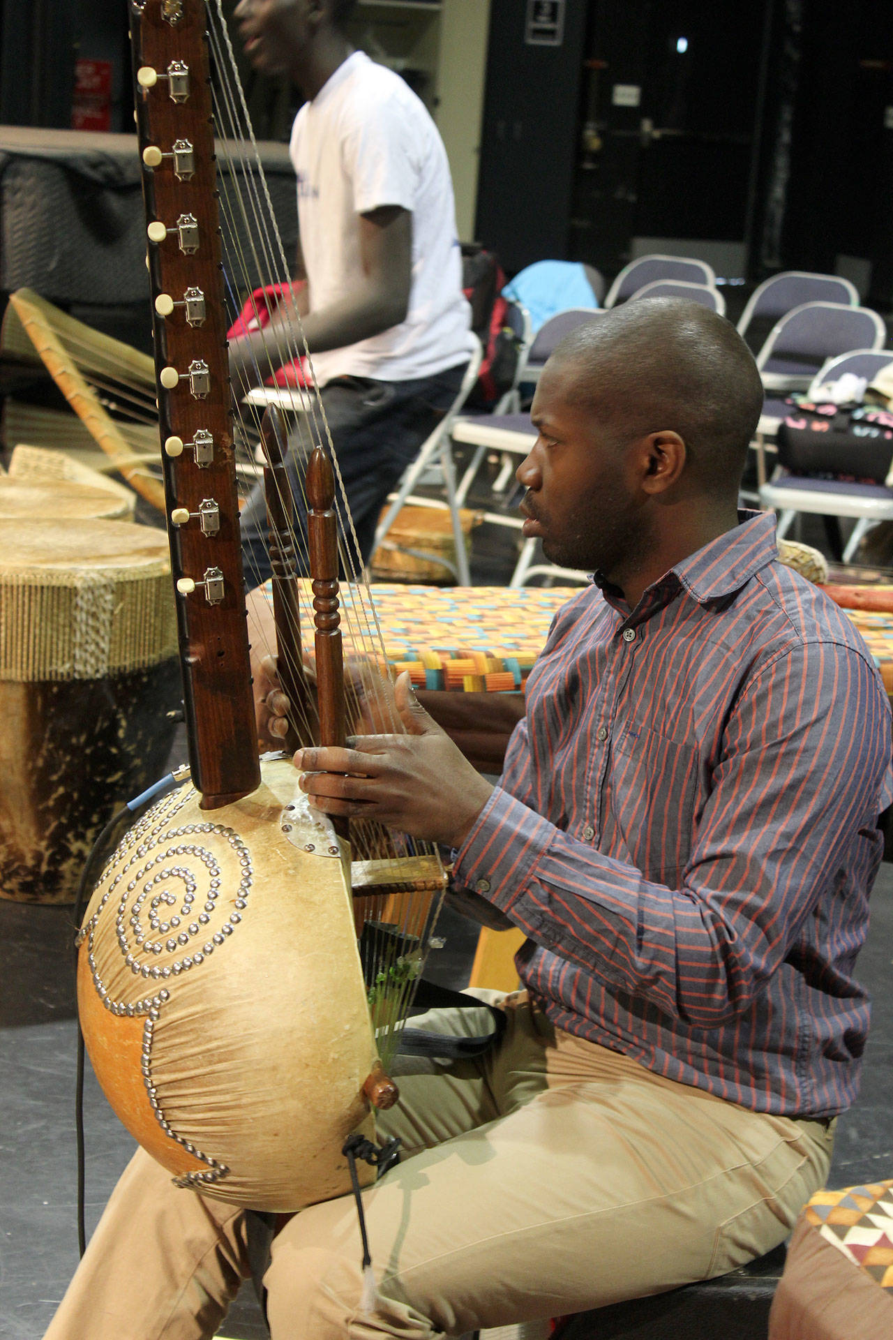 Co-founder of Dance of Hope, Kinobe Herbert, plays an instrument called an adungo.