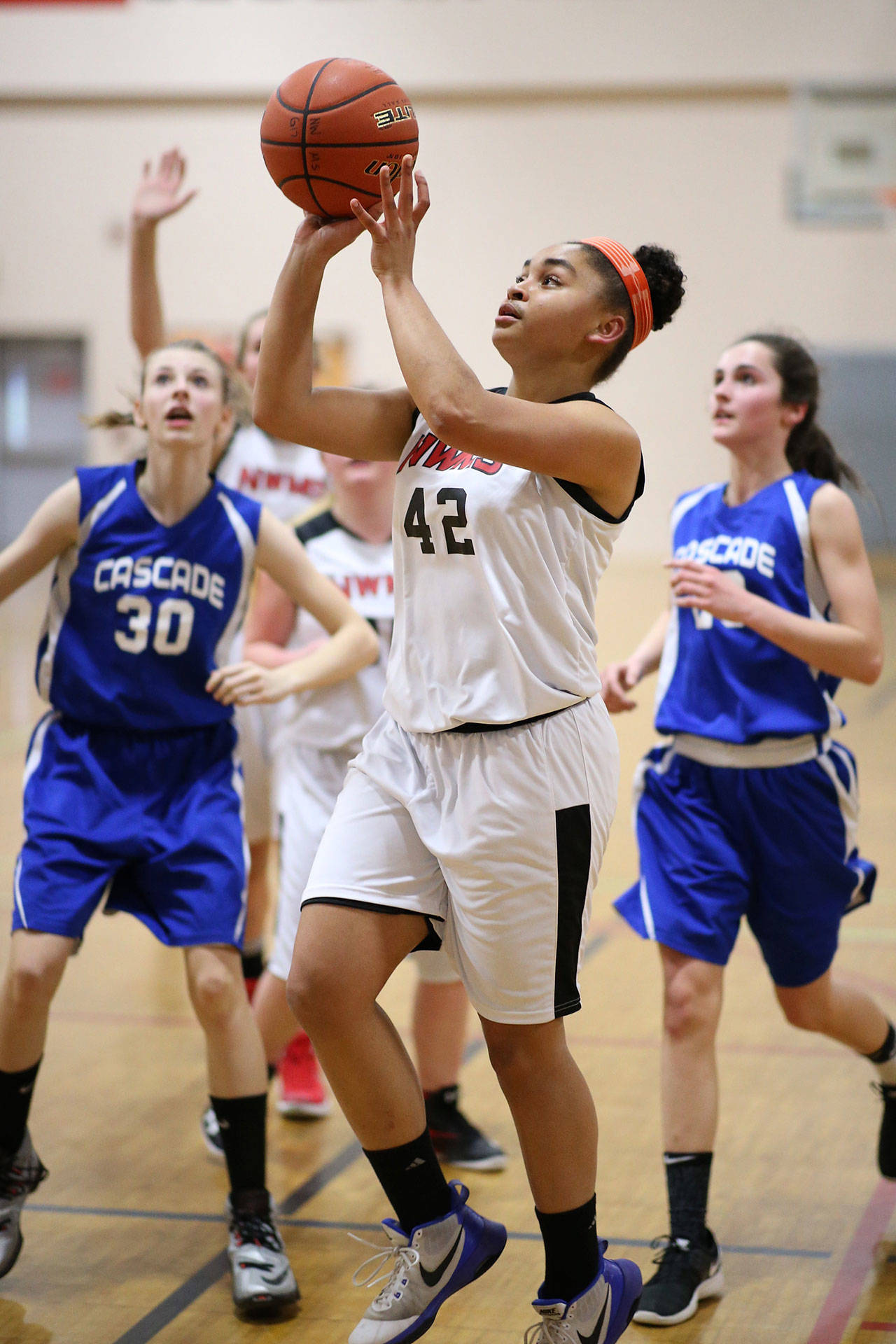 North Whidbey Middle School eighth-grader Tiana Jackson takes the ball to the hoop against Cascade Thursday. (Photo by John Fisken)