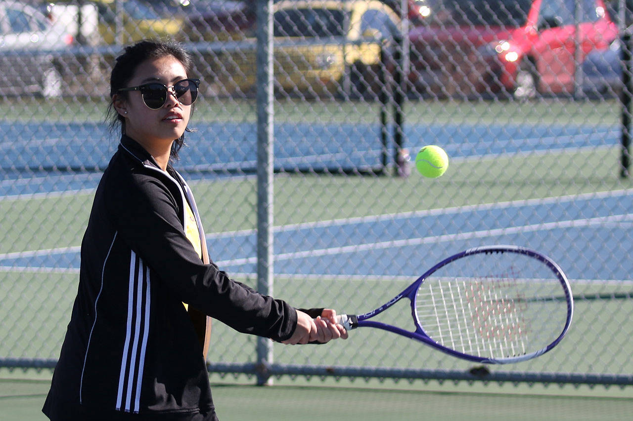 Shaina Aguirre competes for Oak Harbor in first doubles Thursday. (Photo by John Fisken)