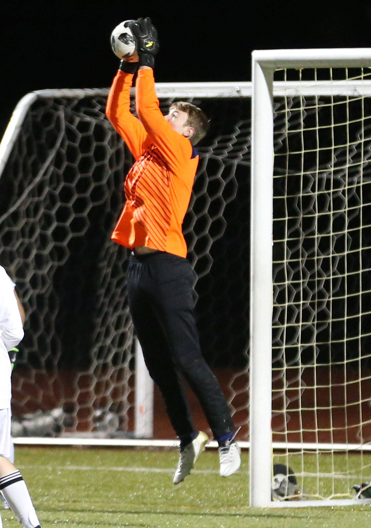 Maxwell Brighton makes a save for Oak Harbor in its match with Lynnwood Tuesday. (Photo by John Fisken)