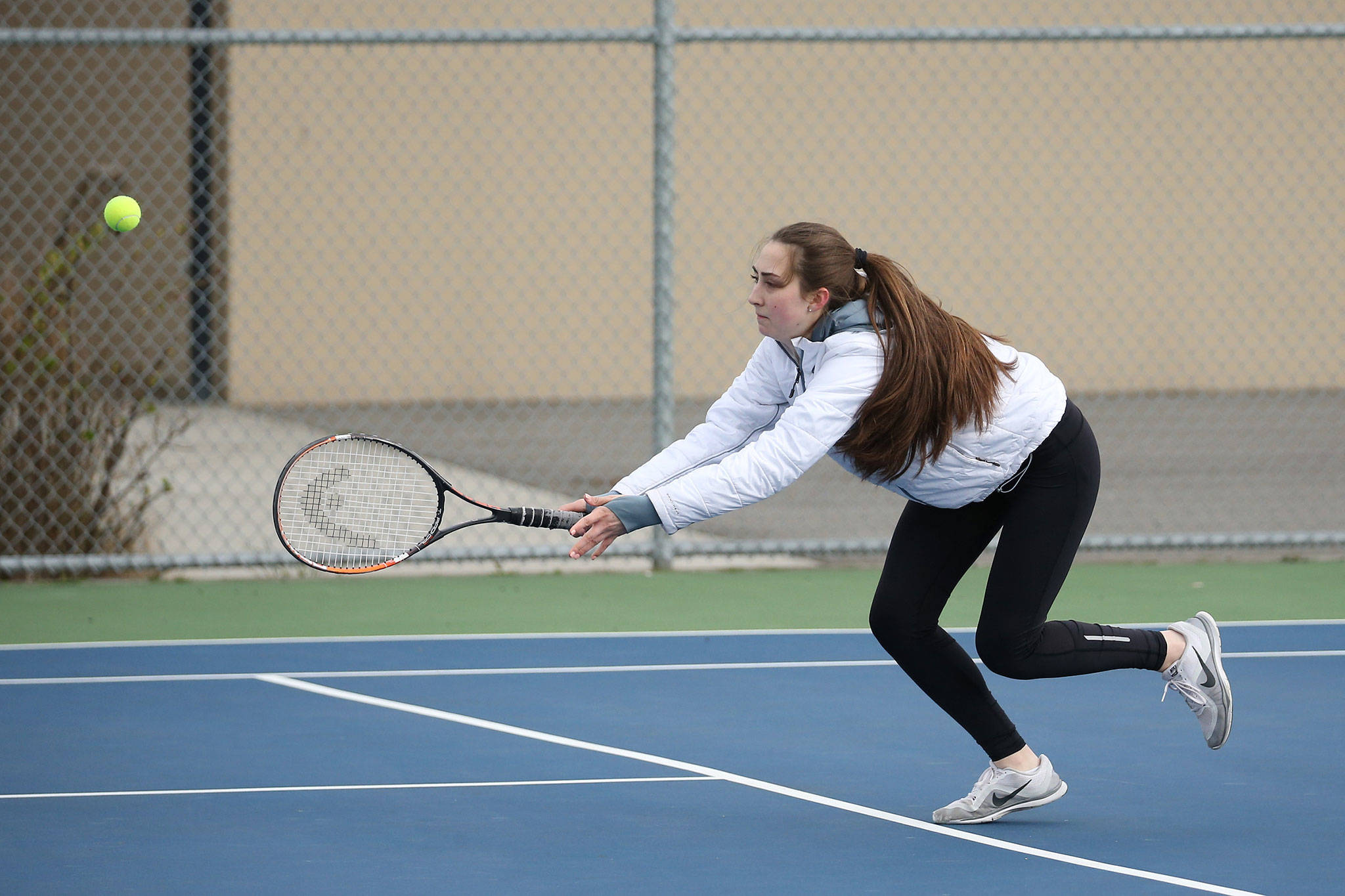 Emily Gouge runs down a shot in her win in third doubles against Everett Friday.(Photo by John Fisken)