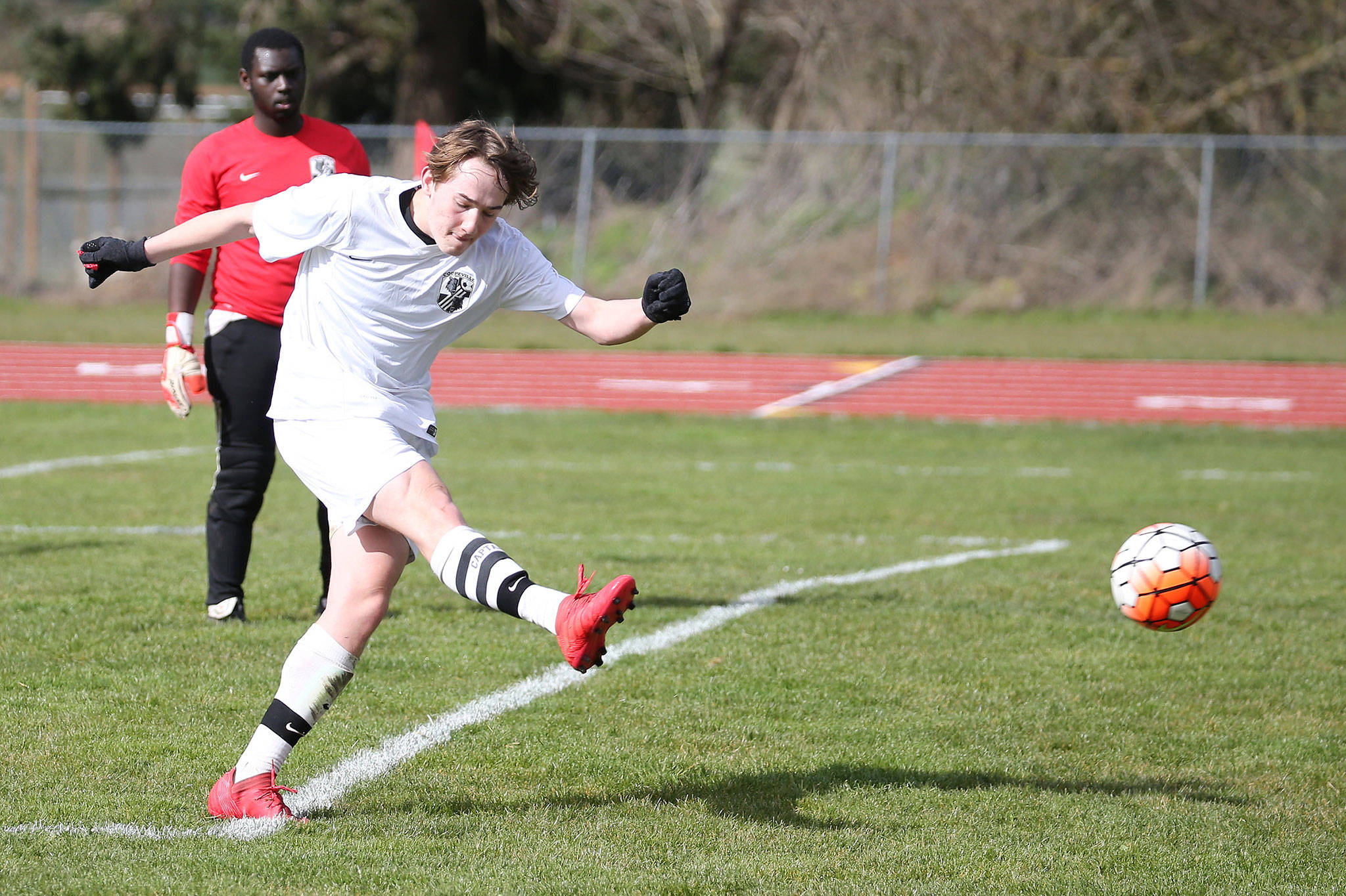 Ethan Spark puts the ball in play in Coupeville’s contest with Klahowya Saturday.(Photo by John Fisken)