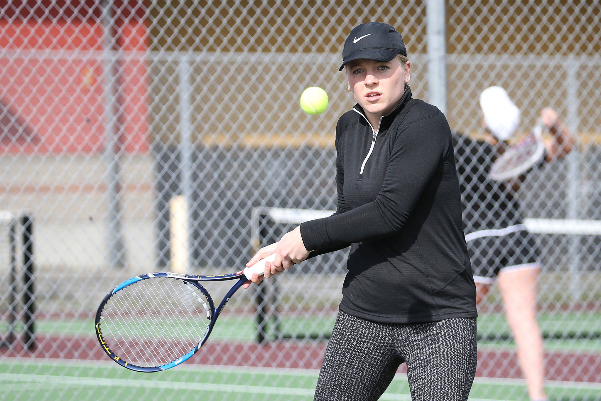 Sage Renninger powers a shot in her first doubles win against Granaite Falls Tuesday.(Photo by John Fisken)
