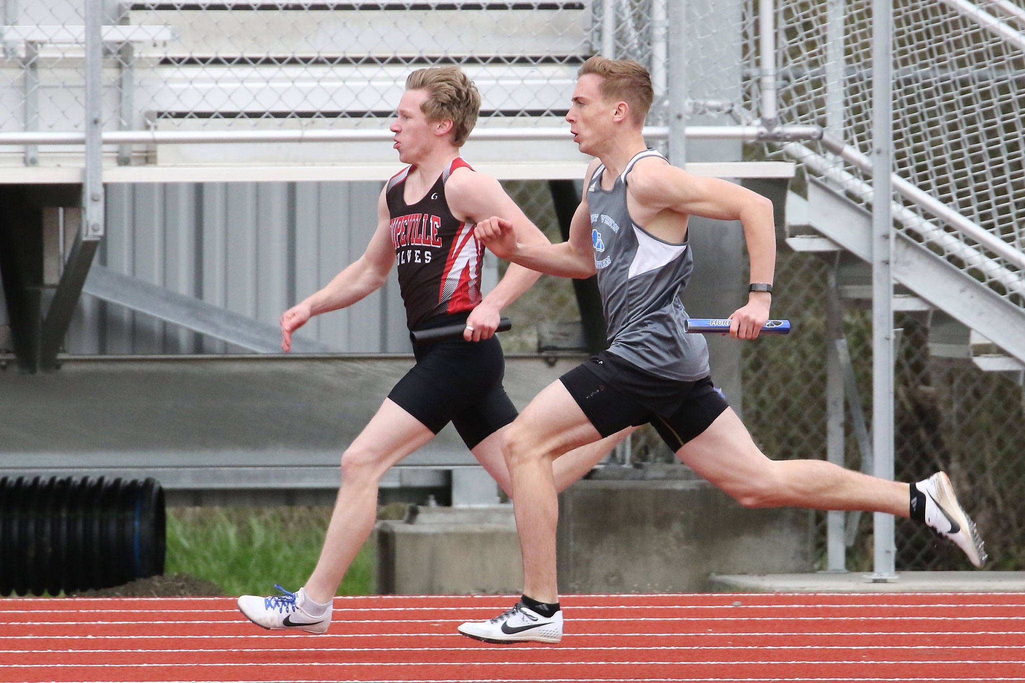 Coupeville’s Jacob Smith, left, races to the finish line in the 4x100 relay Wednesday.(Photo by John Fisken)