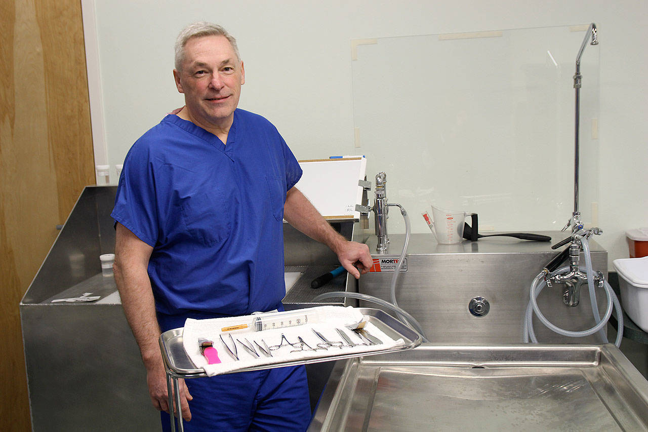 Photo by Jessie Stensland / Whidbey News-Times                                Island County Coroner Robert Bishop prepares for an autopsy.