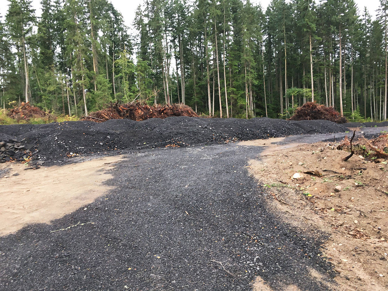 Members of the Whidbey Environmental Action Network have filed complaints to the county regarding large piles of crushed asphalt, such as the ones on a property on Midvale Road. Photo provided