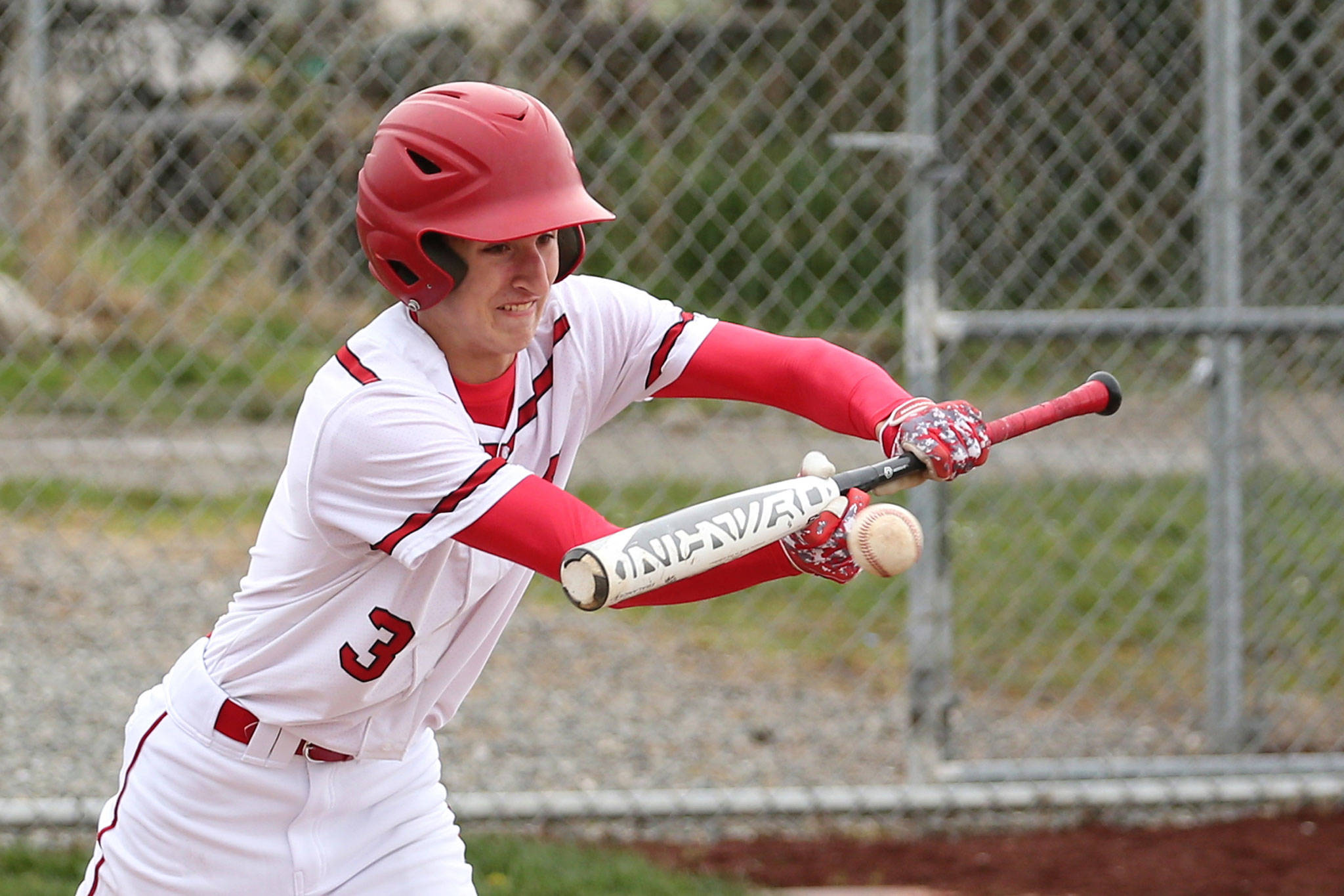 Joey Lippo puts down a bunt for a base hit Saturday. He later ripped a game-tying triple in the eighth inning for the Wolves.(Photo by John Fisken)