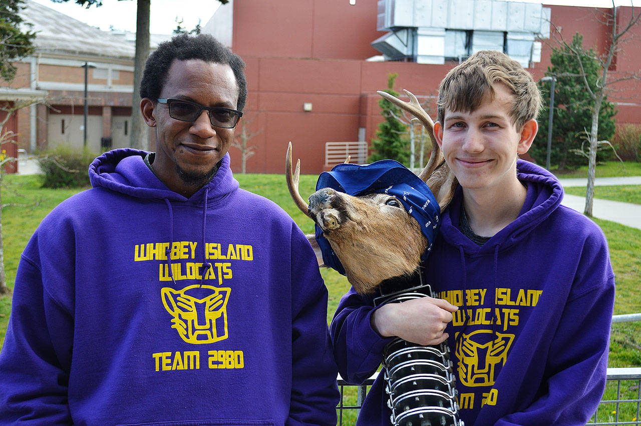 Che Edoga, Wildcats Robotics facilitator, and Logan Ince stand with an animatronic deer head that Ince helped improve for the Department of Fish and Wildlife. Ince has been named a FIRST Robotics Dean’s List Finalist and the team was awarded the Engineering Inspiration Award at districts, which qualifies it for the world championships in Houston. Photo by Laura Guido/Whidbey News Group